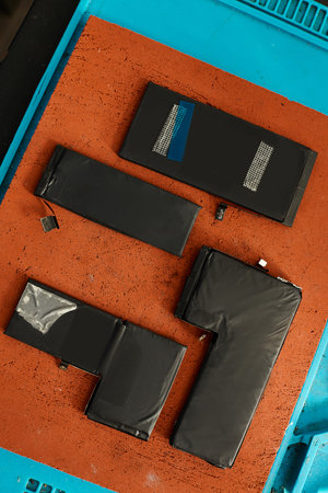 top view of different batteries on table in electronic maintenance workshop, repair business concept