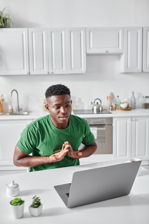 deaf african american freelancer using sign language for communication during video call on laptop