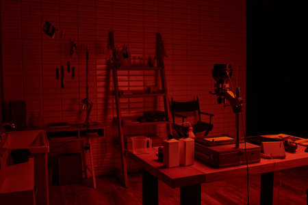 darkroom interior with chemical bottles and tools, showcasing the process of film developmentの写真素材