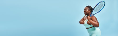 plus size dark skinned woman holding tennis racket on blue backdrop, body positive and sport banner