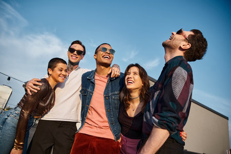 cheerful multicultural friends with fashionable sunglasses having fun together at rooftop party