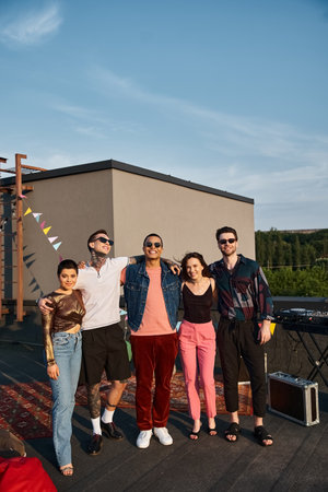 joyous multiracial friends in vibrant attires with sunglasses having fun and smiling at camera