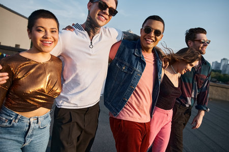 cheerful multicultural friends in casual clothes with sunglasses having fun and smiling at camera