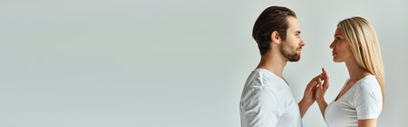 A man and a woman stand face to face, enveloped in a moment of intimacy and romance, bannerの写真素材