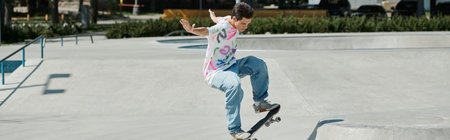 A young man skillfully rides his skateboard up the side of a ramp at a skate park on a sunny summer...