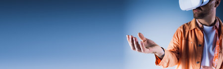 A man confidently wears a stylish white hat and vibrant orange shirt in a virtual reality studio setting.の写真素材