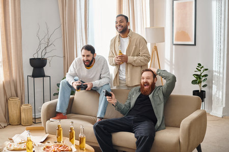 Two interracial men in casual attire sitting on a couch, sharing laughter and camaraderie in a cozy...