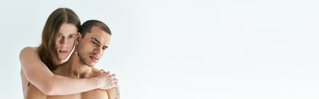 A man tenderly holding his boyfirend in his arms.の写真素材