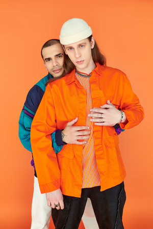Two young men standing next to each other, exuding an aura of connection and love.