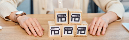 A businesswoman in a modern office plays with a block set on a table, exploring her imaginative and...
