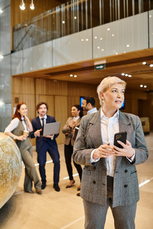 A woman confidently leads an interracial group of business people.の写真素材