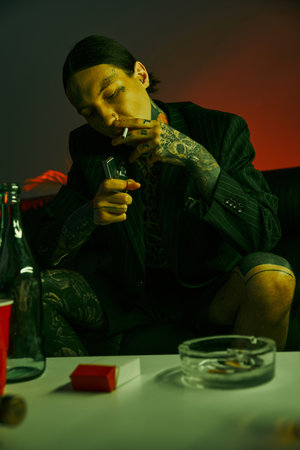 A man sitting on a couch, enjoying a glass of wineの写真素材