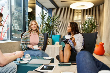 A diverse group of colleagues from a startup team engage in a lively discussion around a table in a...