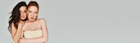 A loving lesbian couple, elegantly dressed, happily posing together.の写真素材