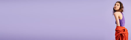 Stylish young woman in a purple top and red pants, exuding confidence and flair against a vibrant...