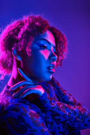 Vibrant African American woman in leopard attire poses confidently.の写真素材