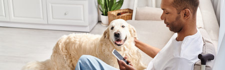 Disabled African American man with myasthenia gravis sitting on a couch, tenderly petting his loyal...