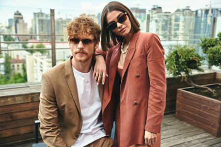 A stylish man and woman striking a pose together, exuding elegance and charm in a picturesque settingの写真素材