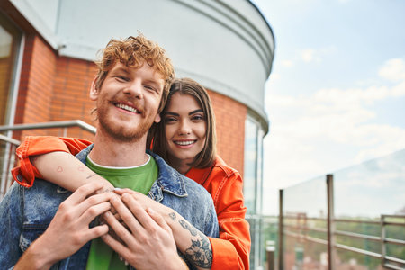 A man tenderly holds a woman in his arms, showing a gesture of care and affection in a serene...