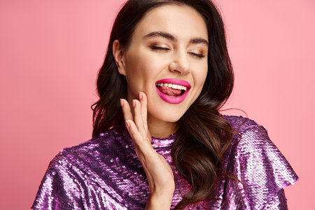 A woman exudes charm in a purple sequin top and pink lipstick.の写真素材