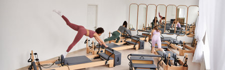 Alluring women engage in a Pilates session in a gym.