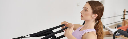 Attractive woman actively practising while on pilates lesson.