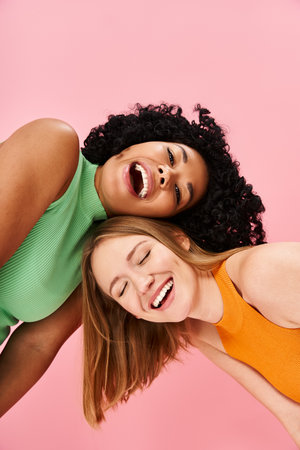 Two young women in casual attire striking poses for a picture.