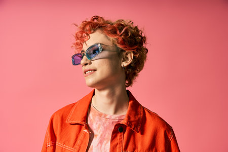 A captivating woman with red hair and sunglasses exudes confidence and style.の写真素材