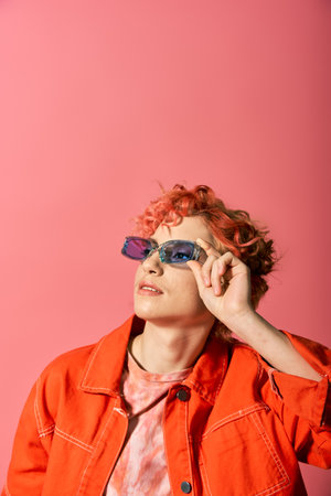 Stylish woman in an orange jacket and sunglasses.
