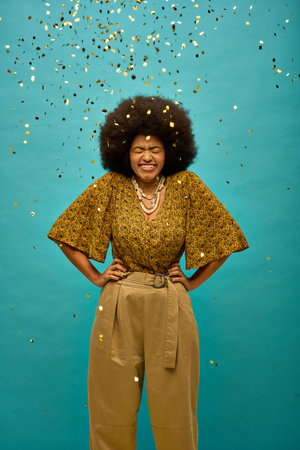 Stylish African American woman in trendy attire standing in front of a blue background with...