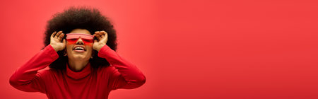 African american woman confidently sports a red shirt and matching glasses.