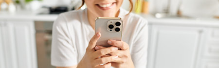 A middle-aged woman holding a cell phone in her hands.