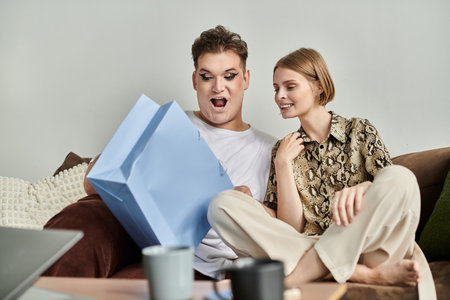Excitement fills the air as a gift is opened among friends in a comfortable setting.