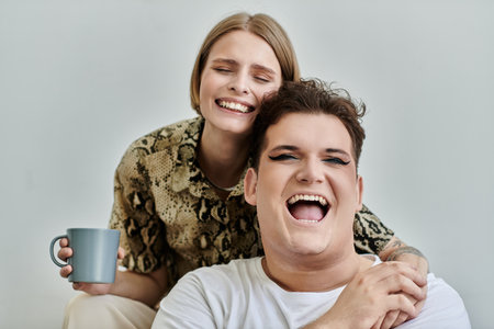 Two friends share joyful moments while relaxing indoors.