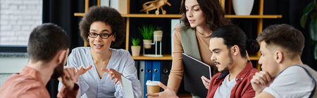 Colleagues engage in a serious discussion while navigating work together.の写真素材