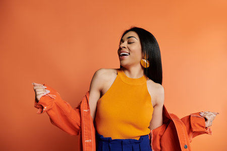 A vibrant, confident woman dances joyfully in a bright setting.の写真素材