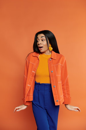 A stylish woman expresses joy, dressed in colorful attire, creating a lively atmosphere.の写真素材