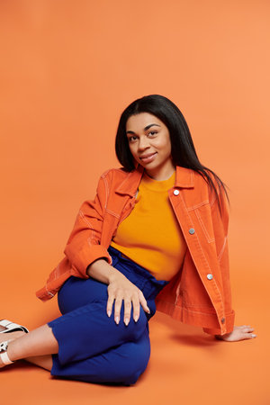 A stylish woman relaxes in colorful clothing, exuding confidence and grace.の写真素材