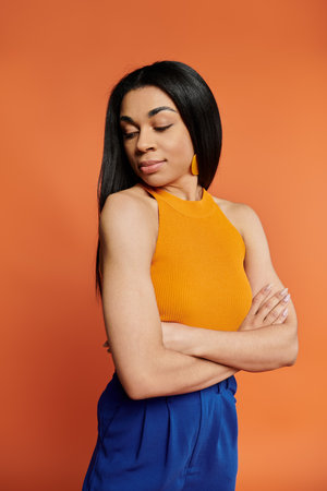 Graceful pose with crossed arms and serene expression in vibrant surroundings.の写真素材