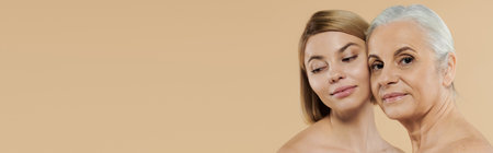 A mature woman and her adult daughter share a tender moment together.の写真素材