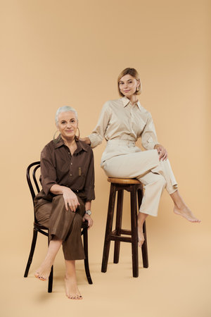 A mature woman and her adult daughter share a warm moment together.の写真素材