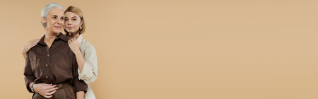 A mature woman and her adult daughter share a heartfelt embrace.の写真素材