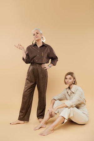 A stylish mature woman and her adult daughter exude confidence in their outfits.の写真素材