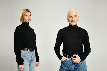 Elegant mother and daughter showcase their fashion sense together.の写真素材