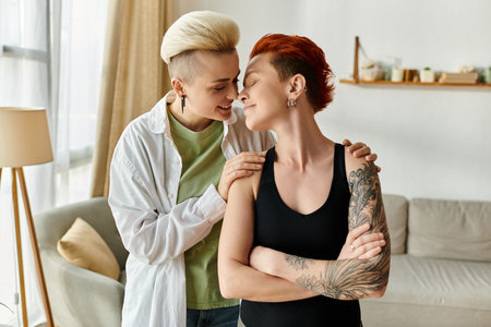 Two women, a lesbian couple with short hair, tenderly hug each other in their cozy living room, showcasing love and unity.の写真素材