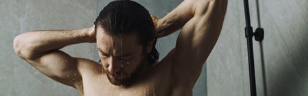 Shirtless man taking a shower.
