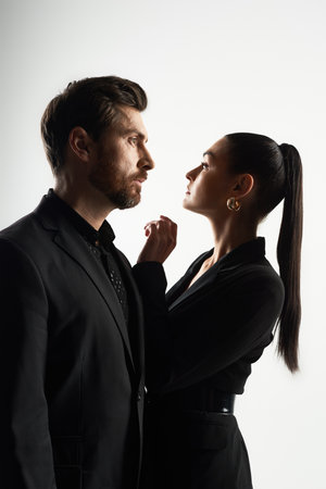 A man and a woman in elegant attire standing closely together.の写真素材