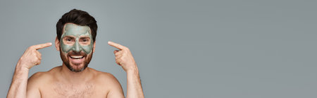 Appealing man wearing a facial mask, skincare.の写真素材