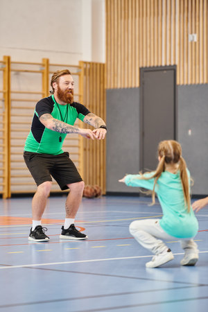 A man and a little girl are immersed in physical education class in school gymの写真素材
