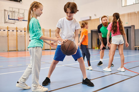 A diverse group of young children playing basketball with enthusiasm and energy in a vibrant setting.の写真素材